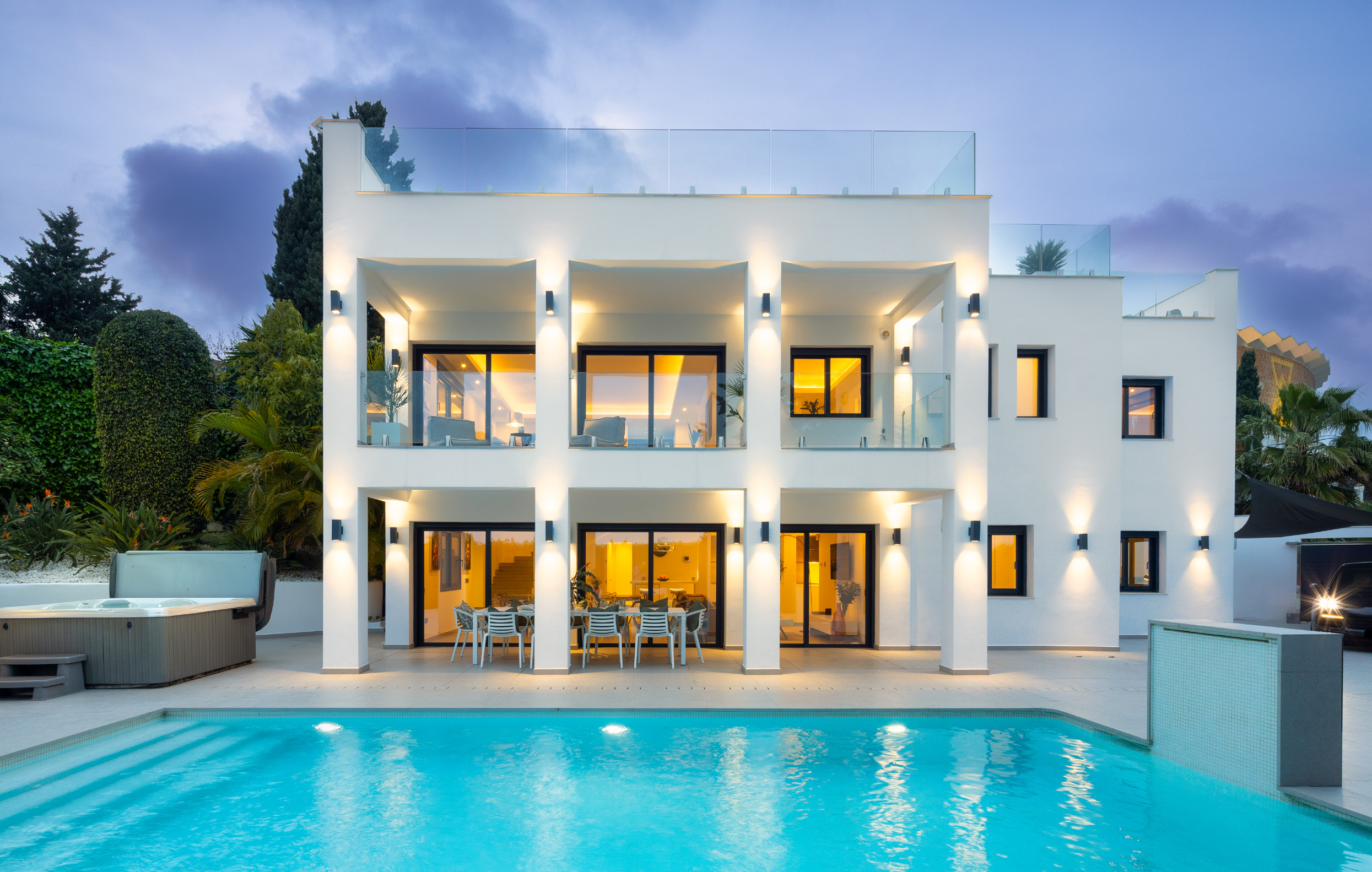 Luxury villa illuminated at twilight with pool