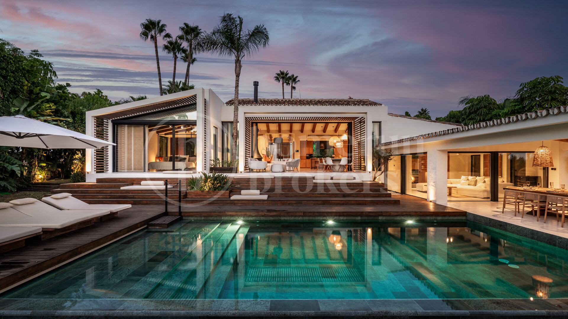Luxury villa at twilight with illuminated pool